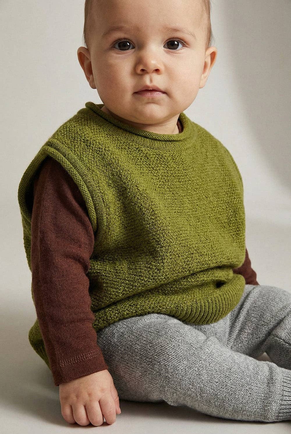 Skandinavische Eleganz für das ganze Jahr. Die federleichte und temperaturausgleichende Strick-Weste aus Merinowolle wärmt, ohne dein Baby einzuengen.